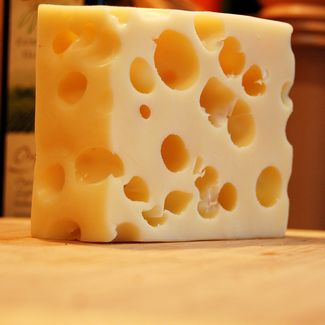 why does swiss cheese have holes