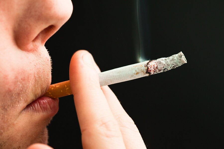 close up of a man smoking