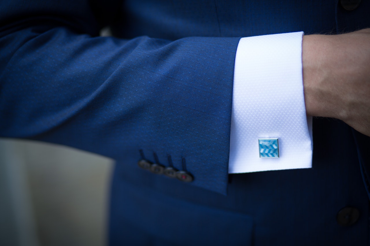Man wearing a blue suit with a blue cufflinks
